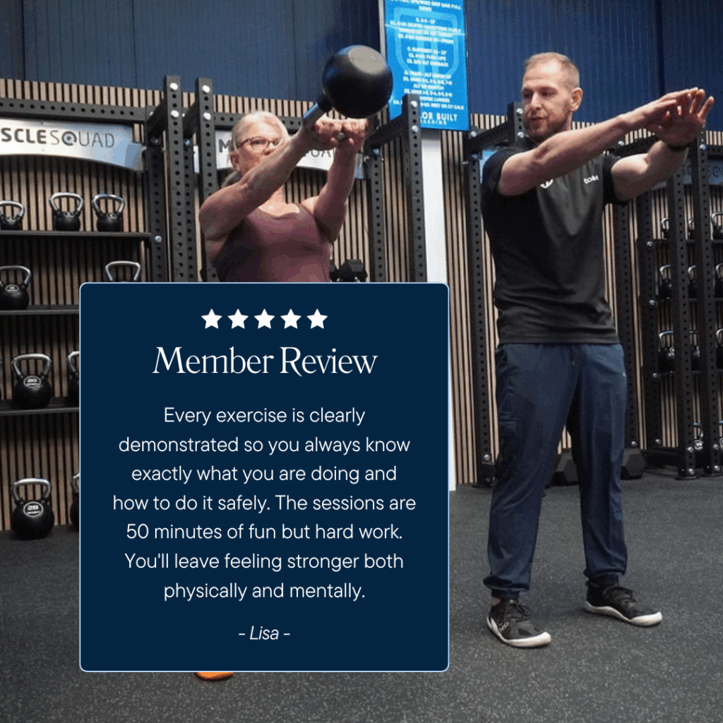 Personal trainer teaching a lady how to do a kettlebell swing
